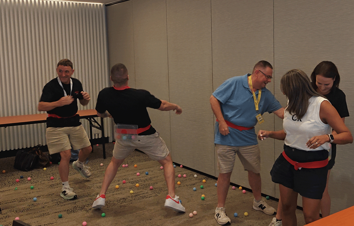 Indoor team building activity used as a wet weather backup plan during corporate event