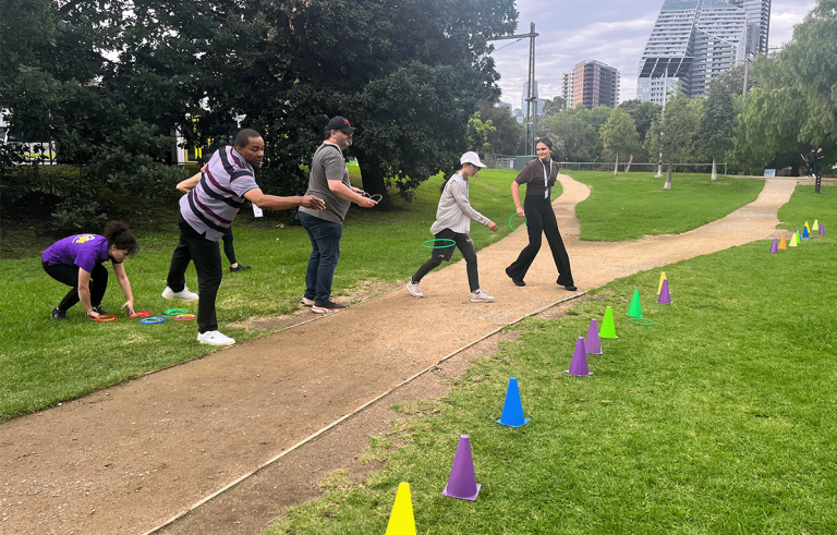 Teams racing through city streets during a multi-city Amazing Race team bonding experience