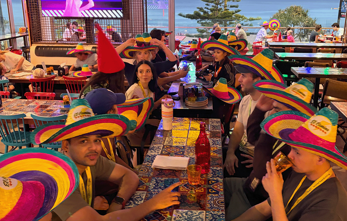 Corporate Amazing Race teams exploring the Gold Coast foreshore during a conference team building event.