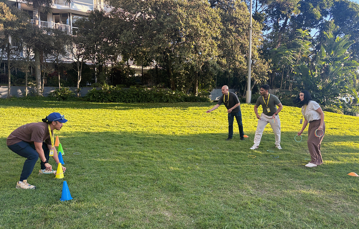 Corporate Amazing Race teams exploring the Gold Coast foreshore during a conference team building event.