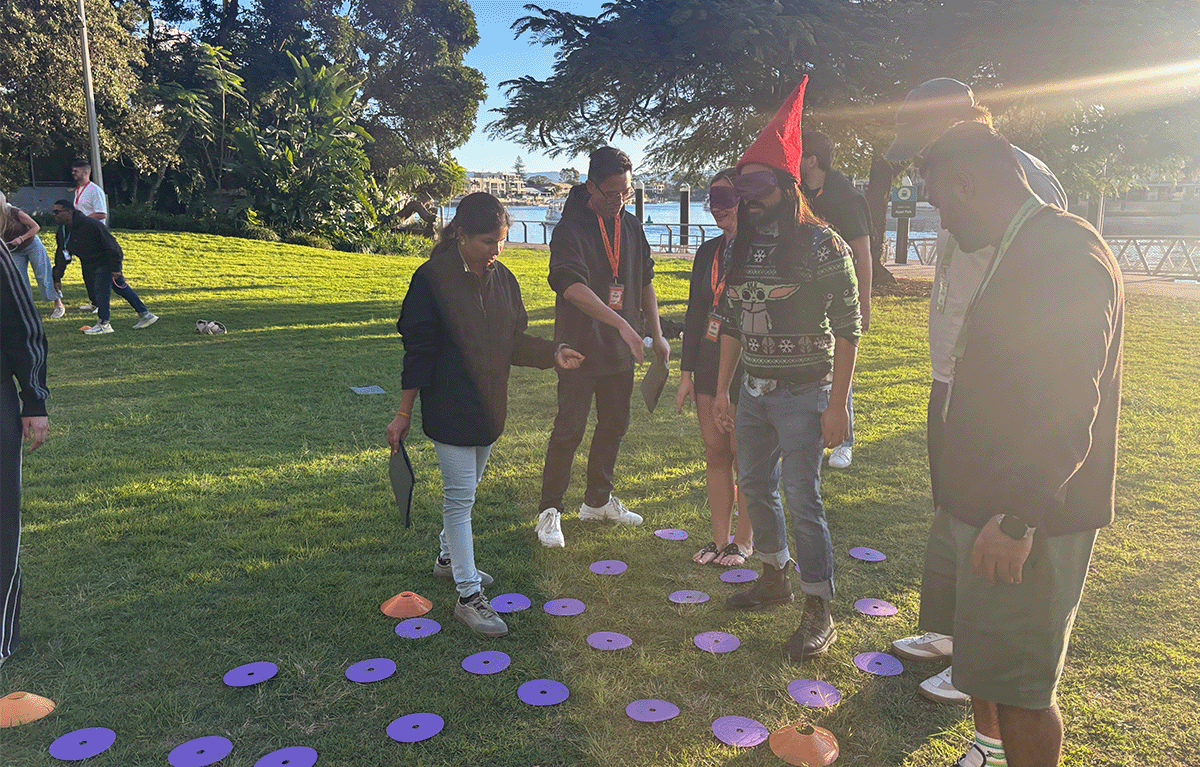 Corporate Amazing Race teams exploring the Gold Coast foreshore during a conference team building event.