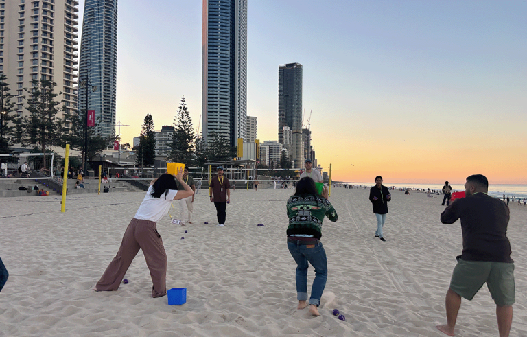 Team building participants constructing sandcastles during a Gold Coast Amazing Race.
