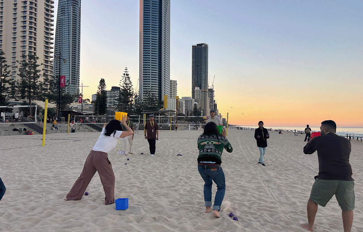 Team building participants constructing sandcastles during a Gold Coast Amazing Race.