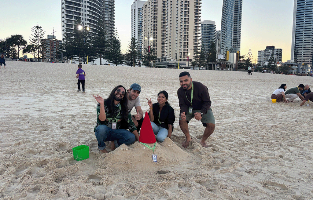 Team building participants constructing sandcastles during a Gold Coast Amazing Race.