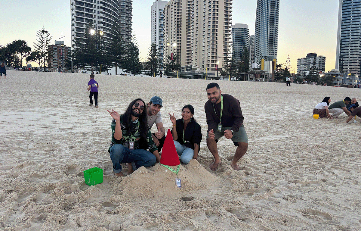 Team building participants constructing sandcastles during a Gold Coast Amazing Race.