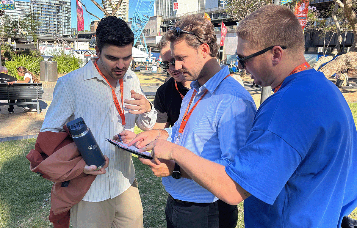 Teams completing interactive challenges during a Multi-City Corporate Amazing Race
