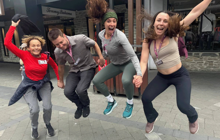Adventure race teams exploring Queenstown streets during a corporate team building event