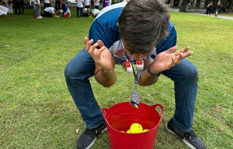 Corporate amazing race Dunedin teams solving clues in the city centre