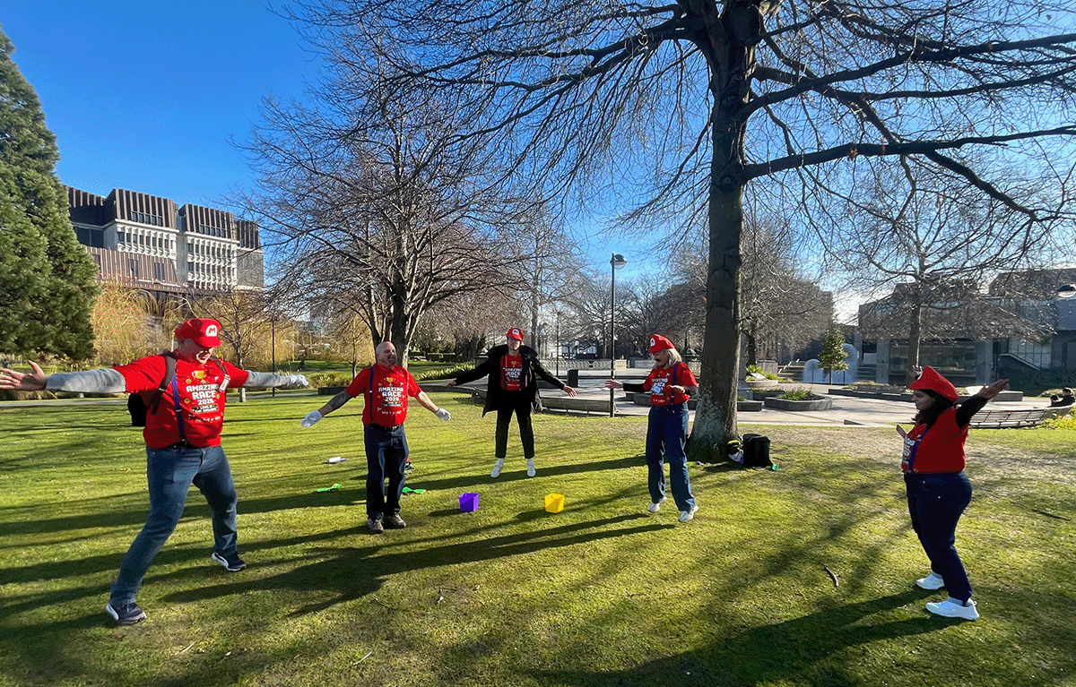 Rave Build teams in colourful outfits during a Christchurch Amazing Race team building event.