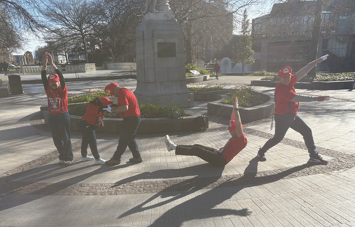 Rave Build teams in colourful outfits during a Christchurch Amazing Race team building event.