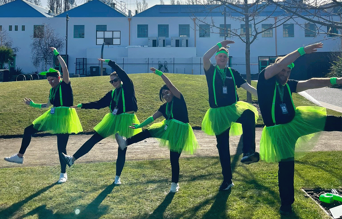 Rave Build teams in colourful outfits during a Christchurch Amazing Race team building event.